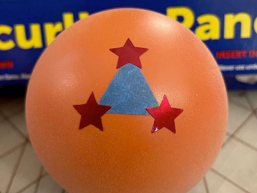 3 star ball showing blue painters tape being used to correctly place the foil star stickers